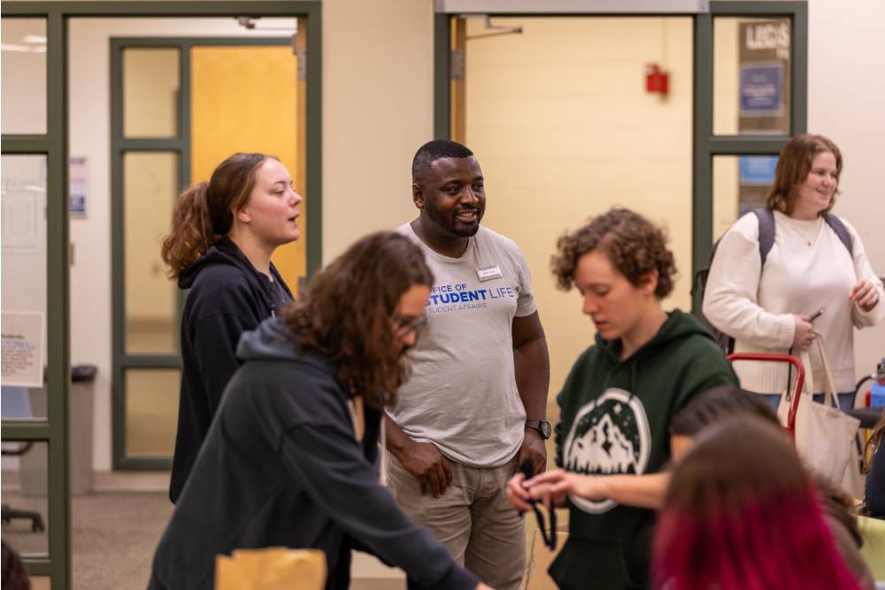 Student Life staff and student interacting